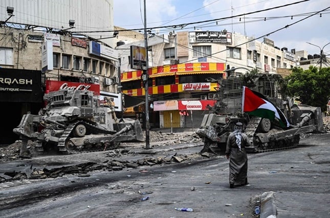 مسنّ يرفع العلم الفلسطيني ويتمشى بين آليات وجرافات جيش الاحتلال  ..  من هو ؟